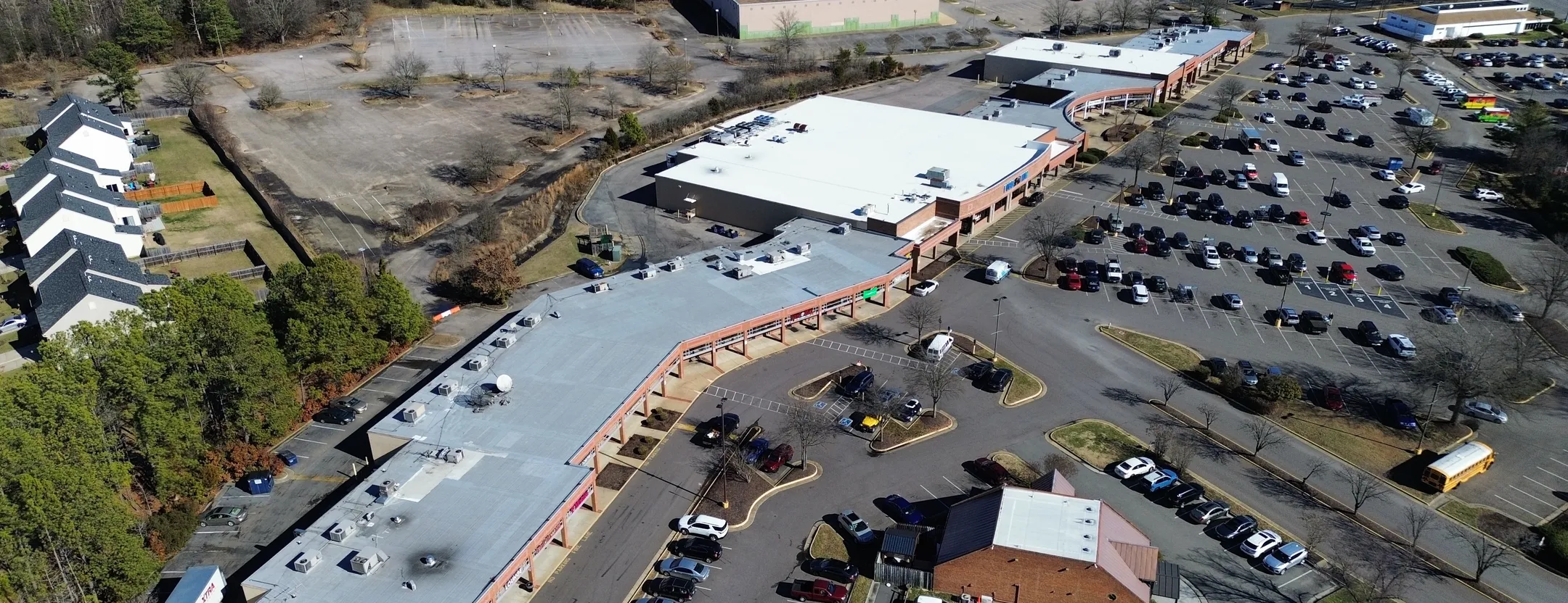 aerial view of parking lot and retail area with new commercial roof